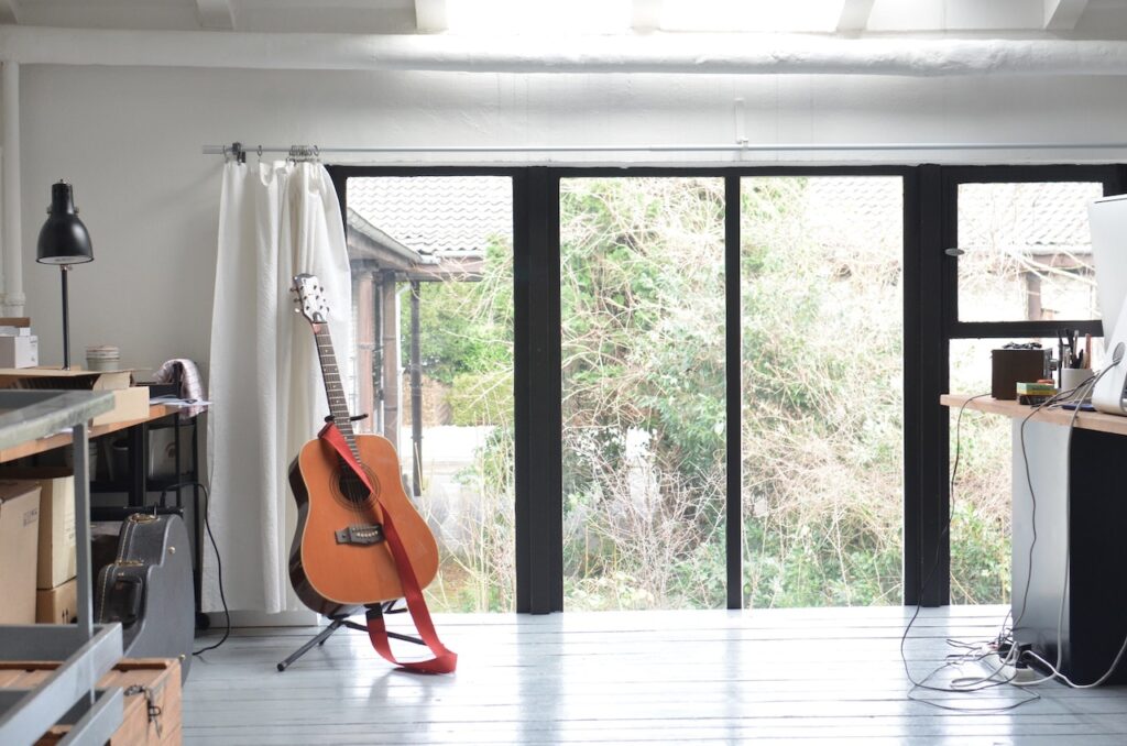 Interior of room for musician with guitar on stand